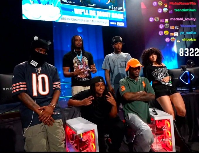 A group of people pose together in front of a large screen displaying "WORLD CHAMPIONS" and "DREAM CON 2024" with the number "8322" visible on the right, exuding a confident and celebratory aura. The post's caption "AURA" fits the scene as the group showcases their strong, unified presence at what appears to be a gaming or esports event.