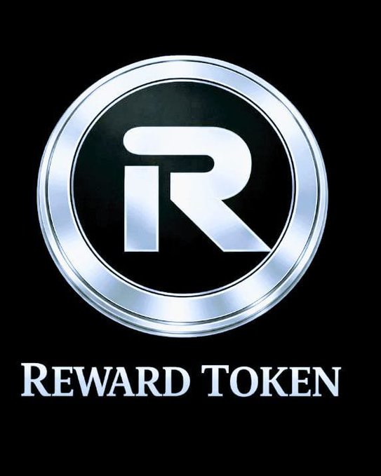 A sleek, metallic "R" logo is displayed inside a silver coin emblem, with "REWARD TOKEN" written below in white text on a black background. The design visually represents the cryptocurrency project mentioned in the post, reflecting its premium, polished branding as it highlights community-driven growth and innovation.