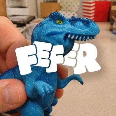 A hand holds a small blue toy dinosaur, with the word 'FEFR' in large white text overlaid across the image.