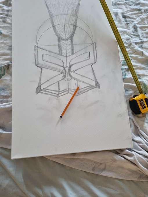 Pencil sketch in progress on white paper showing a geometric symbol/emblem design, with an orange pencil and Stanley tape measure resting on the drawing.
