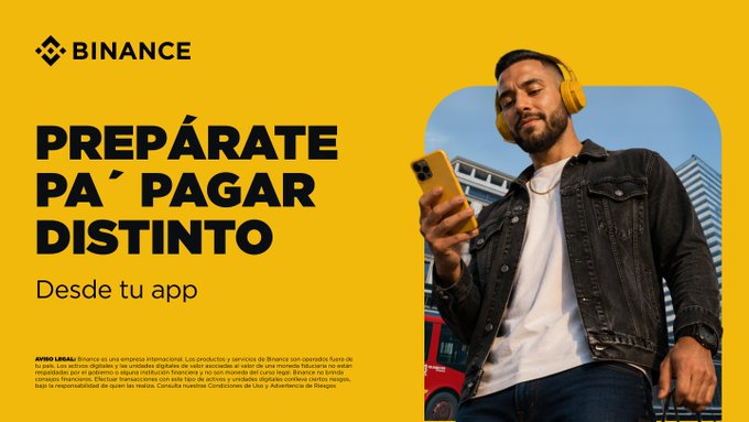A young man wearing a black jacket and yellow headphones smiles while looking at his phone, alongside a Binance ad reading "PREPÁRATE PA' PAGAR DISTINTO - Desde tu app." The image visualizes the post's message by showing someone casually using the Binance app in an everyday urban setting, suggesting convenient crypto payments anywhere—from the parking lot to the hair salon.