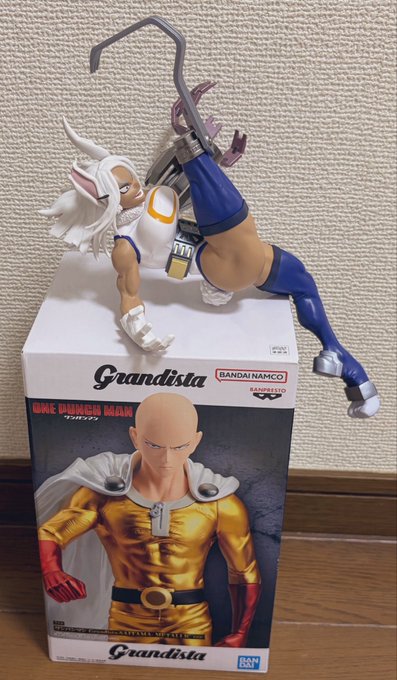 A "Grandista" One Punch Man figurine of Mirko displayed on top of its packaging box featuring Saitama, made by Bandai Namco.