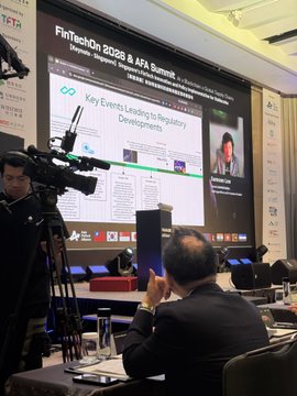 A conference scene shows a large screen titled 'FinTechOn 2026 & AFA Summit' with the heading 'Key Events Leading to Regulatory Developments,' while a cameraman films and attendees watch.