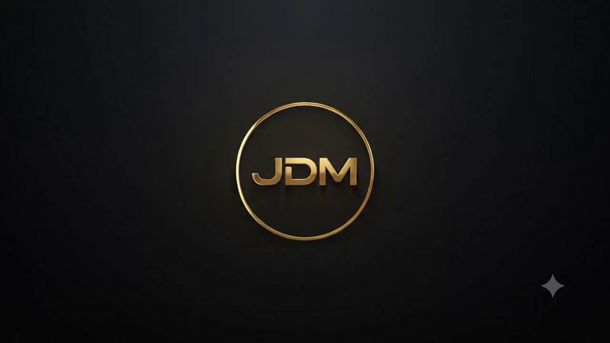 The image features a logo for a company named JDM, which stands out due to its gold color and circular shape. The logo is displayed against a black background, making it the central focus of the image. The caption below the logo reads "It's so much more than #JustDumbMemes, it's bigger, it's better and it's on #Stellar!". This emphasizes the superiority and importance of JDM in comparison to other companies or memes.