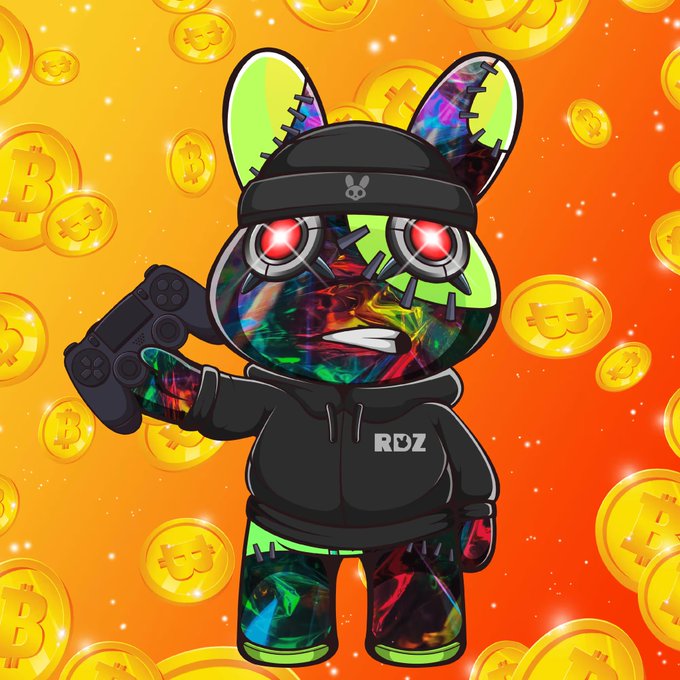 A digital artwork of a colorful, glitchy bear-like character wearing a black hoodie labeled 'RDZ' and a beanie, holding a game controller while surrounded by floating Bitcoin coins on an orange background.