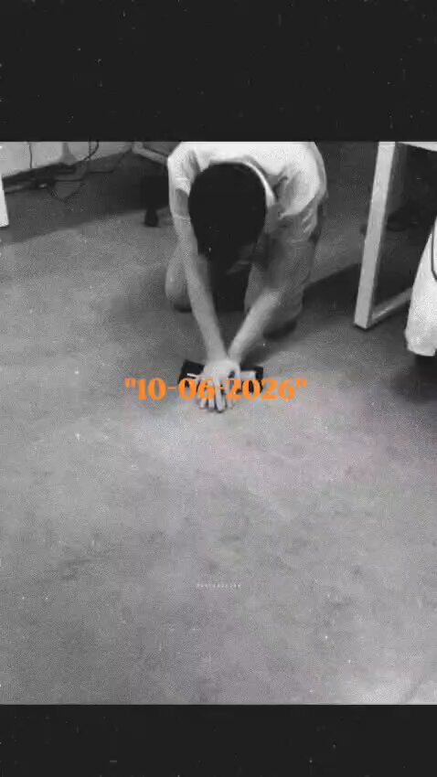 The image shows a person kneeling down on a concrete floor while holding a cell phone. The photo has been edited to include text that reads "10/06/20" at the top, which seems to be a reference to a specific date or event. The image also contains other text elements such as "GM CT not every season is meant for harvesting", "@quipnetwork are both in that phase right now real users already moving on one side, quantum-proof infrastructure with near zero downside on the other". This editing suggests that the photo might be related to a specific event or discussion happening around the time of the image.
