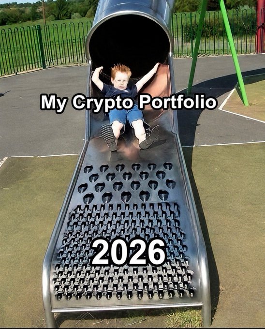 A meme showing a smiling boy sliding down a tube slide at a playground, with the text "My Crypto Portfolio" overlaid on him and "2026" below on the slide.