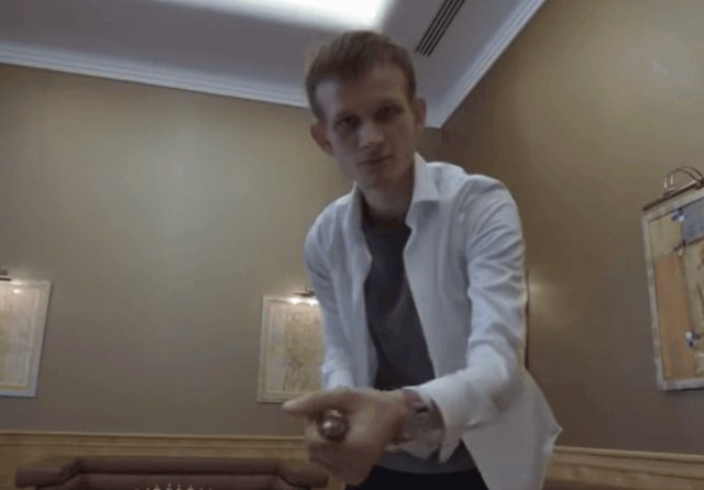 "The State of Ethereum now" is a statement about the current state or condition of the Ethereum blockchain, which is an open-source cryptocurrency. It appears that someone has posted this message on social media platforms like Twitter, Facebook, or Instagram. The image features a man wearing a white shirt and standing in front of a brown couch with a wooden baseball bat leaning against it.
