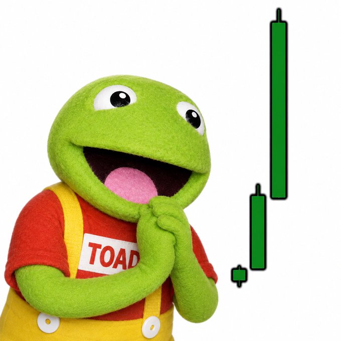 A smiling Kermit the Frog, wearing overalls labeled "TOAD," rests his chin on his hands beside a green candlestick chart showing price recovery with a long upward wick. The image visually echoes the post's "bounced and regrouped" sentiment, pairing the beloved meme frog mascot with the $TOAD ticker to highlight the meme coin's recent rebound.