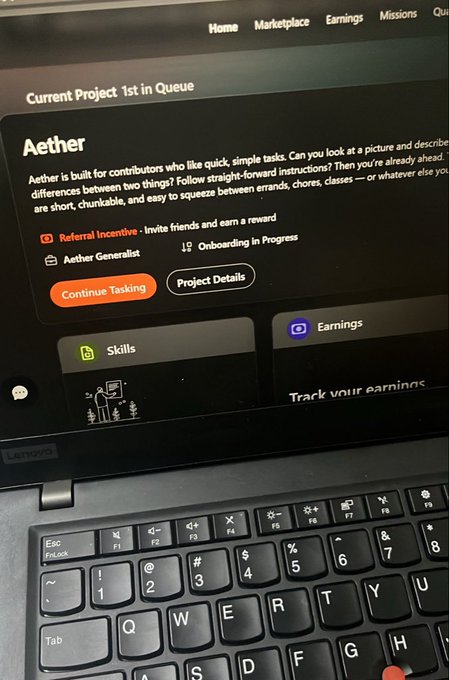 A photo of a Lenovo laptop screen displays a project called 'Aether' described as a platform for contributors to do quick, simple image comparison tasks, with options to 'Continue Tasking' or view 'Project Details'.