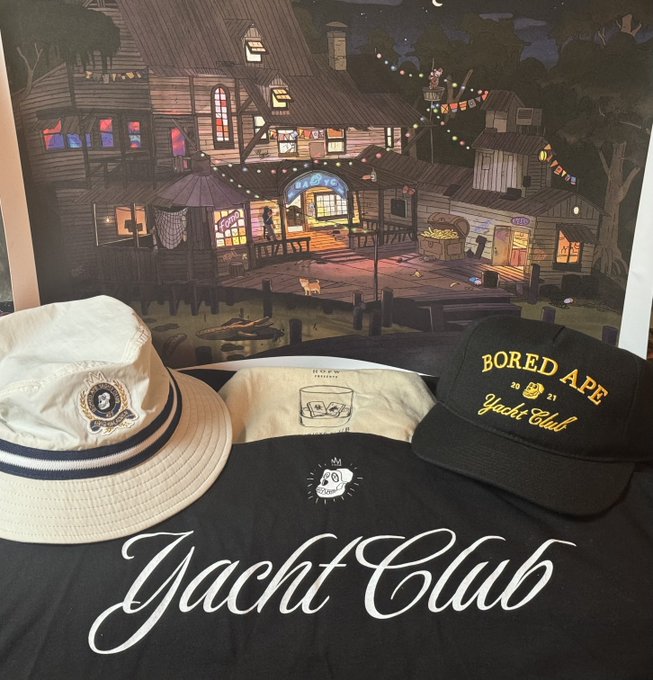 Bored Ape Yacht Club merchandise including a bucket hat, t-shirt, and cap displayed in front of a Yacht Club themed poster.