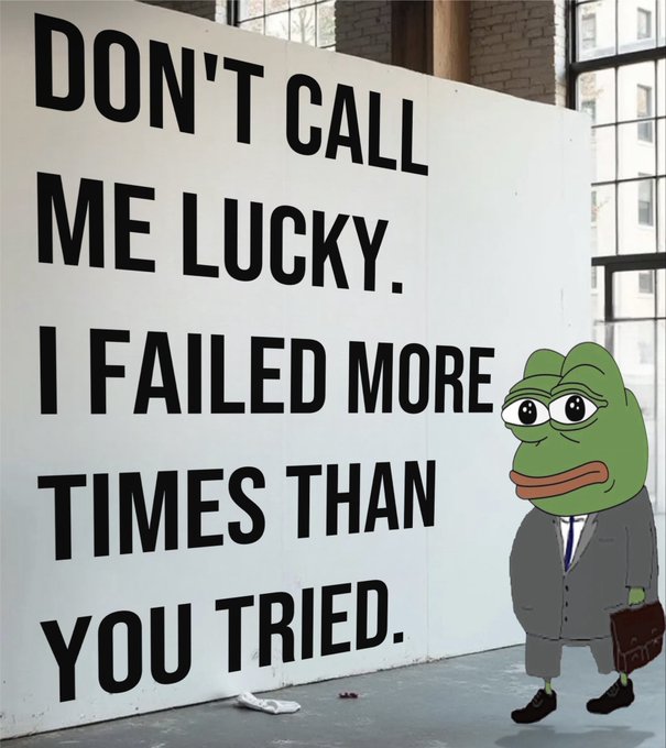 Meme featuring a cartoon Pepe the Frog character dressed in a business suit holding a briefcase, standing next to a large wall displaying the text 'DON'T CALL ME LUCKY. I FAILED MORE TIMES THAN YOU TRIED.'