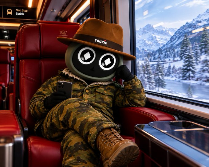 An AI-generated illustration of a character with a round head featuring cartoon eyes wearing a brown hat labeled 'YOUKIE', dressed in camouflage clothing while sitting on a red train seat and looking at a smartphone.