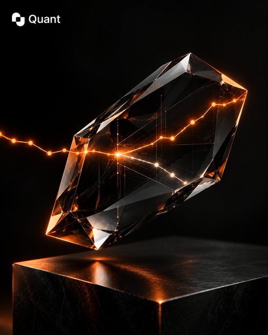 A dark, stylized 3D render of a translucent crystal-like rectangular prism with glowing orange light patterns running through it, sitting on a black pedestal; the 'Quant' logo appears in the top left corner.
