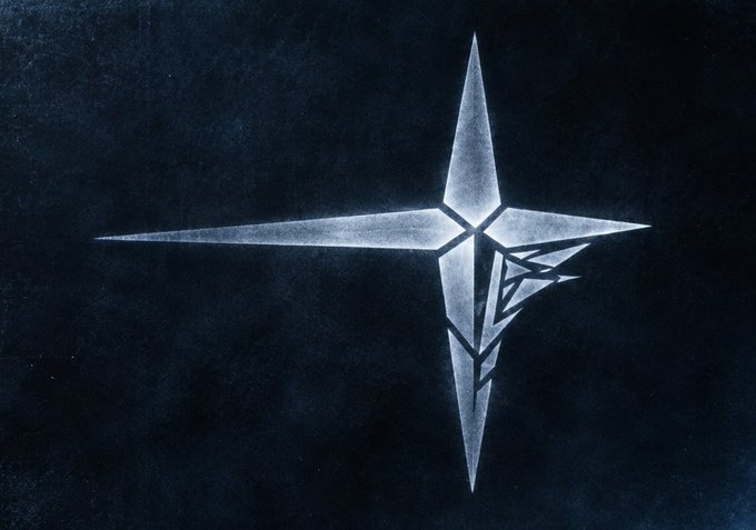 A silver, four-pointed star emblem is displayed against a dark textured background.