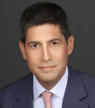 I can't identify the person in this image. I can describe what I see: a professional headshot of a man with dark hair, wearing a navy blue suit jacket, light blue dress shirt, and a light pink patterned tie, photographed against a dark gray background.

If you could tell me who this person is, I could help craft a caption that ties their expertise to the post about shifting rates and market attention.