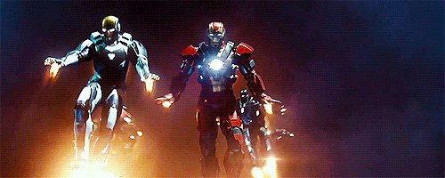 The image features a group of people standing next to each other, with one person holding a light source that appears to be an Iron Man suit. The caption reads "Building your agent on @base is like giving your agent an Ironman suit". This suggests that the image is related to the Marvel Cinematic Universe and specifically to the character Iron Man from the movies.