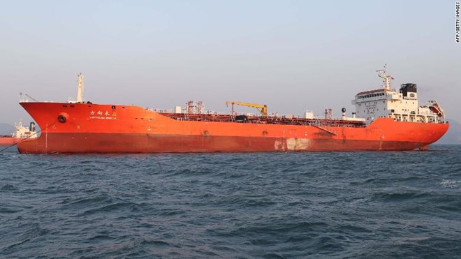 An orange oil tanker ship on the ocean, credited to AFP/Getty Images.