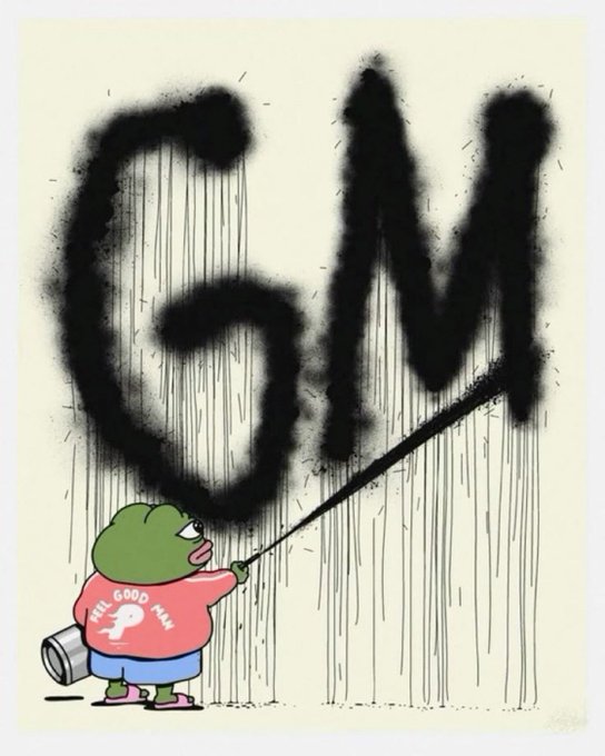 A cartoon illustration shows a green frog-like character wearing a pink shirt that reads "FEEL GOOD MAN" spray-painting the large black letters "GM" on a wall with a dripping effect.