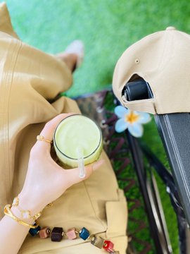The image features a person sitting outdoors, holding a glass of green smoothie with a straw. The scene includes a chair nearby, suggesting that this outdoor setting could be a relaxing spot for enjoying a refreshing drink. In the background, there are two bicycles parked against each other, indicating that someone might have been cycling before settling down to enjoy their smoothie. Additionally, there is a potted plant and a flower in the image, adding some natural elements to the scene. The post about Bitcoin and altcoins seems unrelated to this specific image but could be related to an event or trend happening elsewhere on social media that caught the person's attention while they were enjoying their smoothie outdoors.