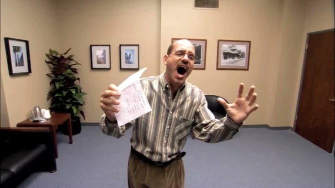A bald man in a striped shirt in an office setting, holding up a paper showing financial figures while appearing to shout with an exaggerated expression.
