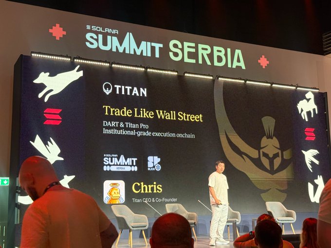 A man stands on stage at the SOLANA SUMMIT SERBIA event, presenting 'Trade Like Wall Street' for DART & Titan Pro, with text identifying the speaker as Chris, Titan CEO & Co-Founder.