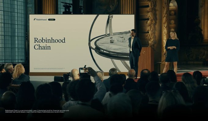 Robinhood executives announce their new Layer 2 blockchain, "Robinhood Chain," on stage at an event, with a large screen displaying the brand name alongside an architectural image. The presentation aligns with the post's discussion of Lighter's $20 million incentive commitment to the platform and Robinhood's coverage of gas fees for the first 90 days.