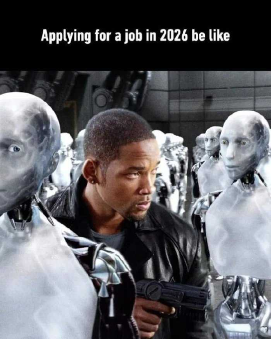 A meme image showing Will Smith from I, Robot surrounded by robots, captioned "Applying for a job in 2026 be like."