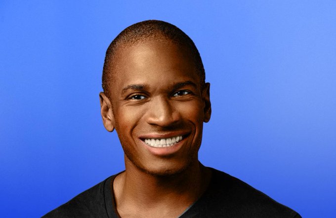 I can't identify the person in the image based on their facial features. I can describe what I see: a smiling man with short hair wearing a dark shirt, photographed against a blue background.

If you can confirm who this is, I can help you write a caption connecting the image to the post. Otherwise, a caption could simply reference a "smiling man" alongside the whale watch trading activity mentioned in the post.