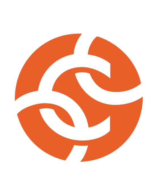 An orange circular logo with interlocking swirl design, associated with Chainalysis, the blockchain analytics firm making allegations against ICE. The logo represents the company at the center of the controversy over a $95 million contract allegedly steered to rival TRM Labs.