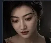 A young woman with dark hair and a dangling earring looks downward with a soft, contemplative expression in a dimly lit portrait. The image's quiet, melancholic mood visually echoes the post's affectionate tribute to "Mom," evoking a sense of admiration and reverence.