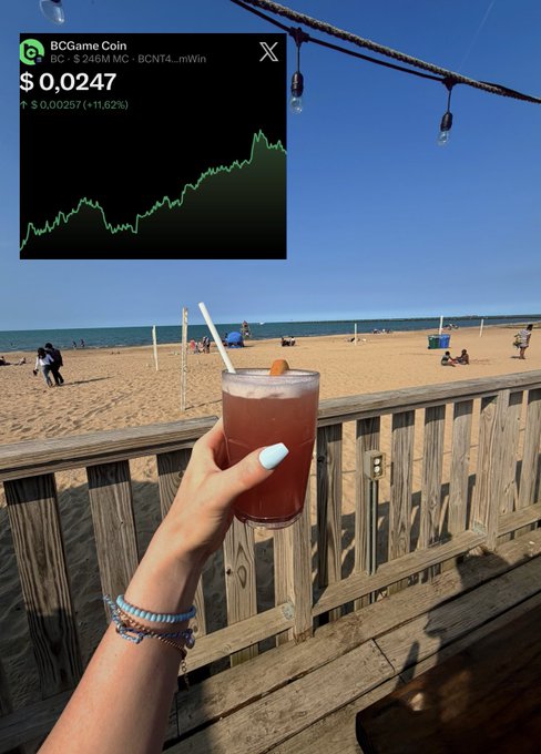 A hand holds a red beverage at a beachside deck, with a crypto price chart overlay showing "BCGame Coin" (BC) at $0.0247, up 11.62% to $0.00257.