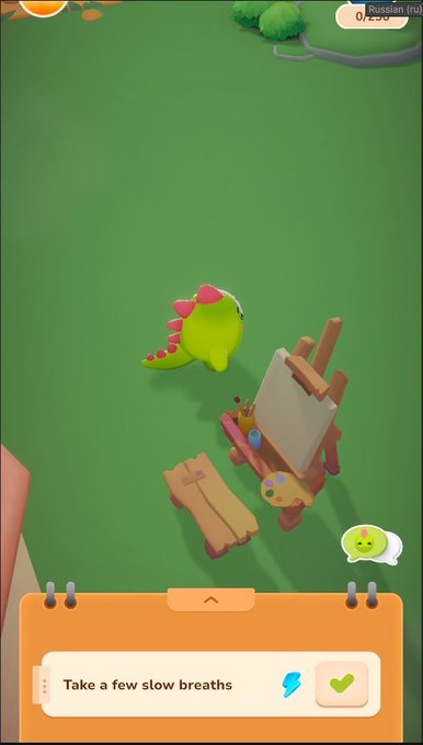 The image shows a cartoon dinosaur sitting next to an easel with paintbrushes, suggesting that the dinosaur might be painting or drawing something. The scene takes place outdoors, possibly in a park setting. There are also two small figures present in the image, one of which is a person holding a book and another figure resembling a bird.