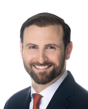 The image shows a professional headshot of a smiling man with brown hair, a well-groomed beard, and blue eyes. He is wearing a dark suit jacket, white dress shirt, and a red patterned tie, photographed against a plain white background. The post context suggests this is Patrick Witt, the White House crypto adviser referenced in the update, who is reportedly making progress on crypto legislation discussions with Senator Cynthia Lummis regarding ethics provisions, stablecoin rewards, and yields ahead of a September 15 Senate procedural vote.
