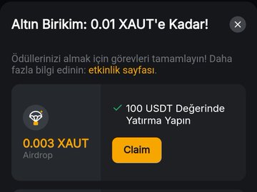A cryptocurrency airdrop notification in Turkish offering up to 0.01 XAUT, requiring completing tasks like investing 100 USDT, with 0.003 XAUT currently available to claim.