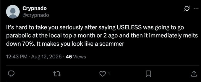 A tweet from user @crypnado dated Aug 12, 2026, reads: "It's hard to take you seriously after saying USELESS was going to go parabolic at the local top a month or 2 ago and then it immediately melts down 70%. It makes you look like a scammer," criticizing bullish $USELESS predictions as the post's author defends their continued buying despite the criticism.