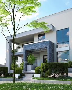 A modern two-story house with white and dark gray stone facade features large windows, balconies, and a landscaped front yard with green grass and bushes.