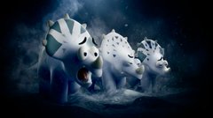 Dark, moody image featuring small white plush or figurine characters with blue accents, possibly Coraline-inspired, arranged in a shadowy blue-toned setting.