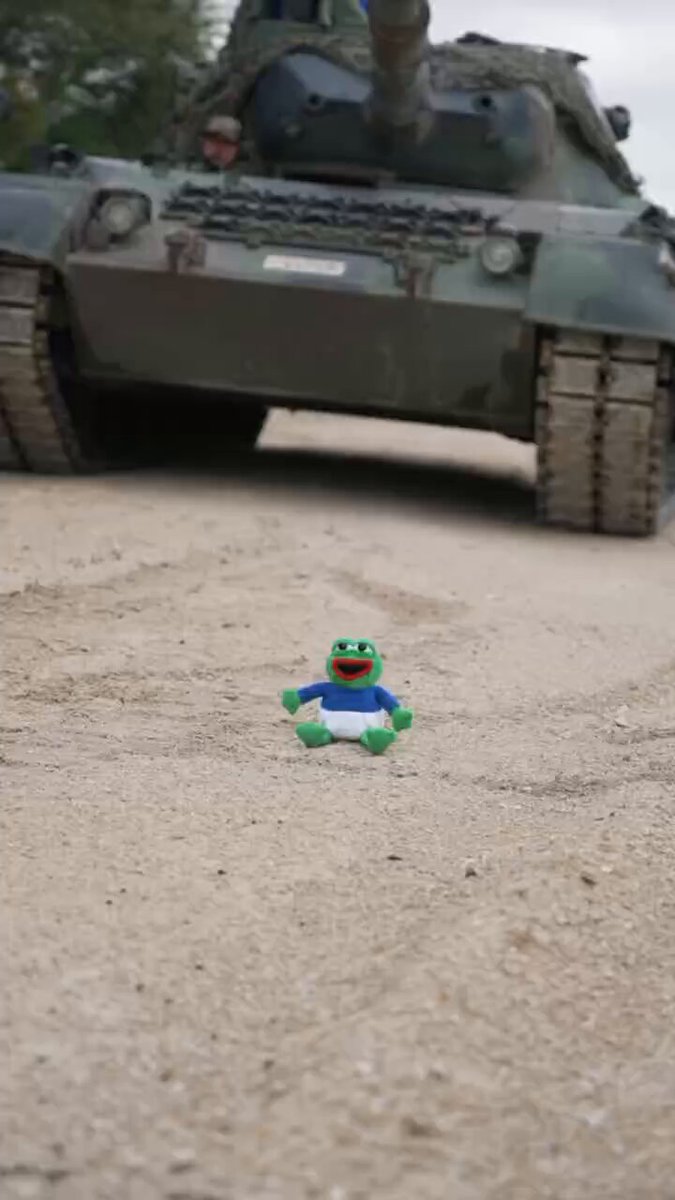 The image features a small toy frog sitting on a dirt road, with a large green military tank behind it. The text "PEPE AINT Got Shit On Me" is written below the photo of the toy frog.