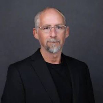 A professional headshot of a bearded man with glasses wearing a black blazer, identified as Adam Back, accompanies a bullish post suggesting his prediction that Bitcoin could reach $1,000,000 if Wall Street allocates just 2% to $BTC.