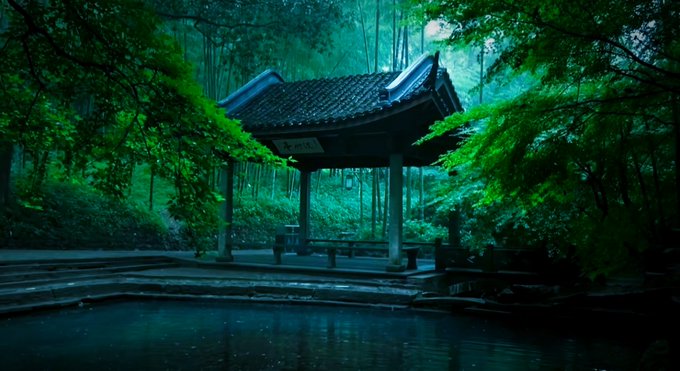 A serene Japanese pavilion with a tiled roof surrounded by lush green bamboo and trees, bathed in a mystical teal light.