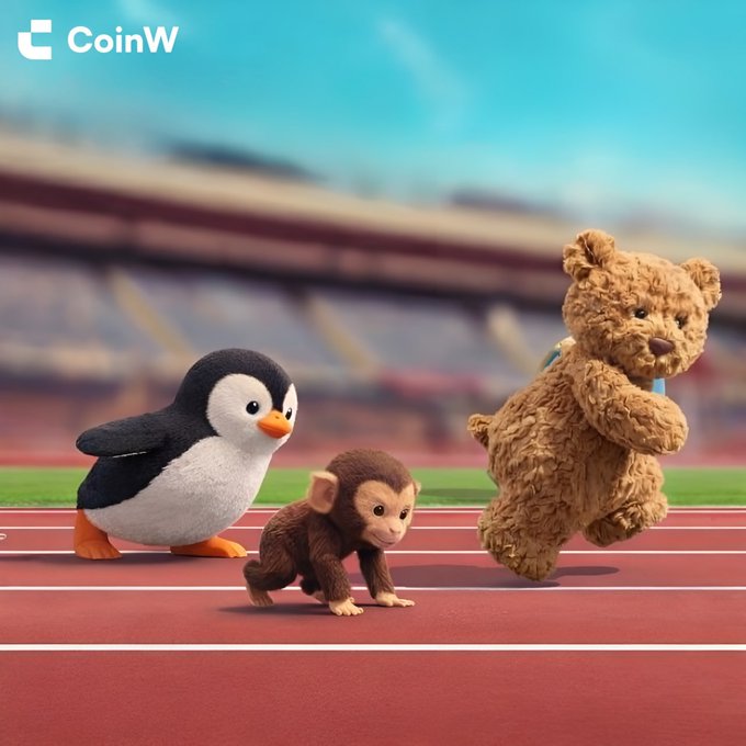 A plush penguin, monkey, and teddy bear race on a track in a stadium, with the "CoinW" logo displayed in the top left. The playful image illustrates the "GM" (Good Morning) greeting through the cute mascots energetically starting their day.