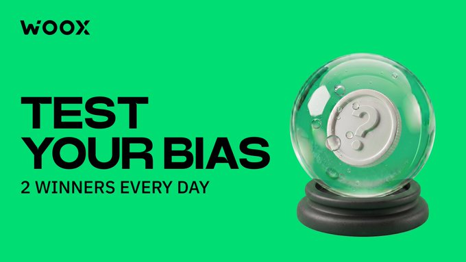 The image features a glass ball with a question mark on it, placed on top of a black base. The background color of the image is green. Below the glass ball, there's text that reads "Test Your Bias". The text also mentions two winners and suggests they will be rewarded for their efforts in May.