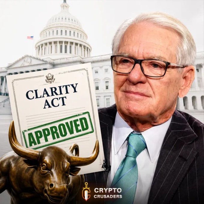A composite image features an older man in glasses and a suit holding a document titled 'CLARITY ACT' stamped 'APPROVED' in green, with the U.S. Capitol behind him, a bronze bull statue in the foreground, and a 'CRYPTO CRUSADERS' logo.