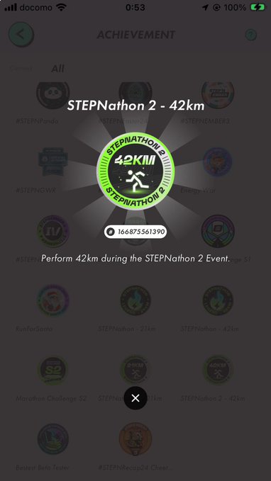 A smartphone screenshot of an achievement screen displaying a 'STEPNathon 2 - 42km' badge with instructions to 'Perform 42km during the STEPNathon 2 Event,' shown over a blurred background of other achievements.