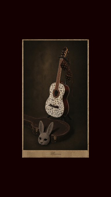 A still life photograph featuring a small, ornately decorated acoustic guitar with floral detailing, accompanied by a white rabbit mask resting on a brown guitar case, set against a moody dark background. At the bottom of the image, the word "Unknown" appears in elegant script, matching the artwork's title shared in the post celebrating its sale to an anonymous collector.