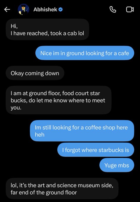 Text message conversation with Abhishek (verified) discussing meeting up at a Starbucks in a mall, with one person taking a cab and the other forgetting where Starbucks is, humorously noting 'Yuge mbs'