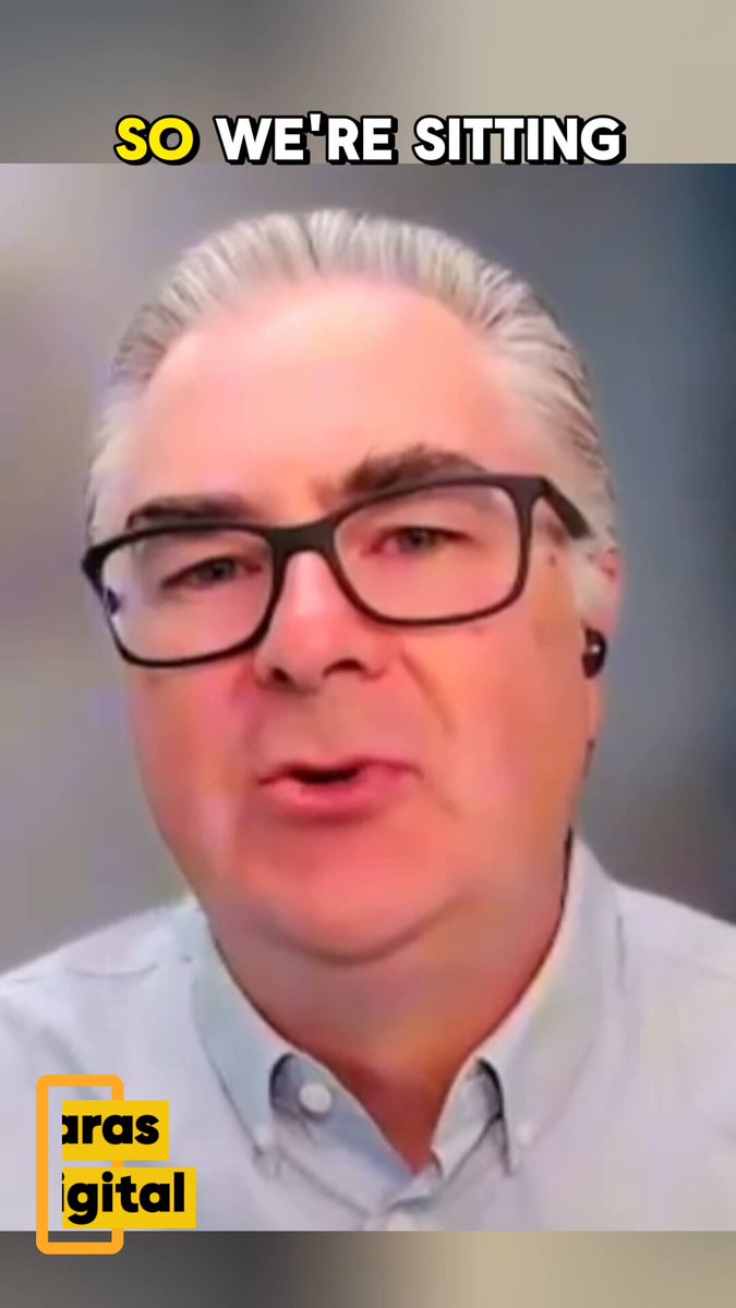 The image features a man wearing glasses with his mouth open as if he's speaking or making a statement. The caption of the image reads "So We're Sitting" which seems to be a humorous response to a question posed by someone else on social media. The image also includes a logo for Arras Digital, suggesting that it might be related to an online platform or service.