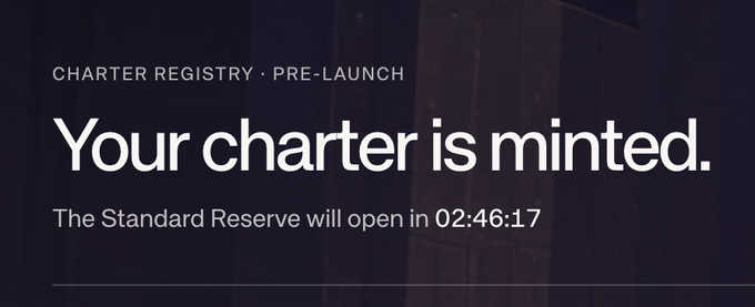 A dark screen displays white text reading 'CHARTER REGISTRY · PRE-LAUNCH' and 'Your charter is minted.' with a countdown timer below stating 'The Standard Reserve will open in 02:46:17'.