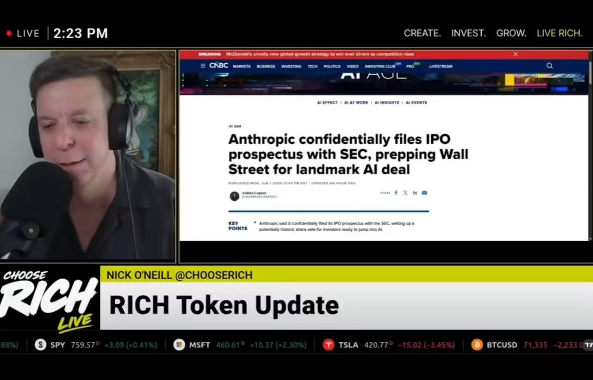 The image shows a news screen with a headline about an anthropomorphic investment firm called Hyper Liquid. The text on the screen reads "Anthropic Confidently Files IPO Prospectus with SEC Preparing IPO Wall Street for landmark AI deal." A man is also visible in the image, wearing headphones and talking into a microphone.